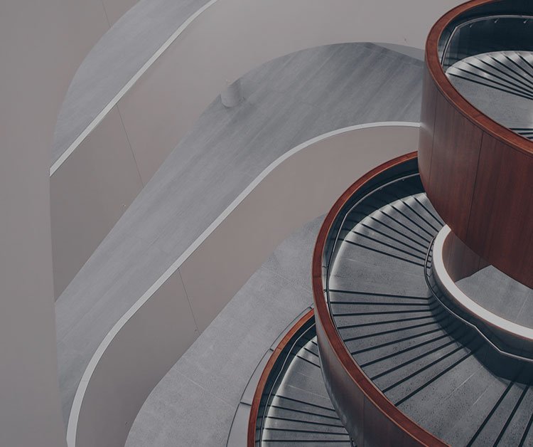 Aerial view of a modern spiral staircase featuring wooden and metal elements.