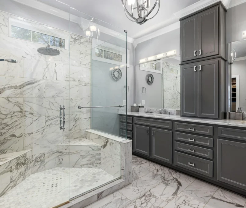 A luxurious bathroom featuring elegant marble countertops and a spacious walk-in shower.