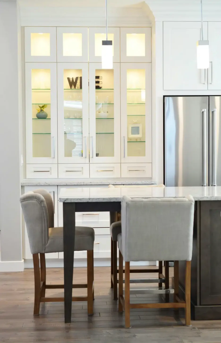 A cozy kitchen featuring a wooden table surrounded by chairs, creating an inviting dining space.