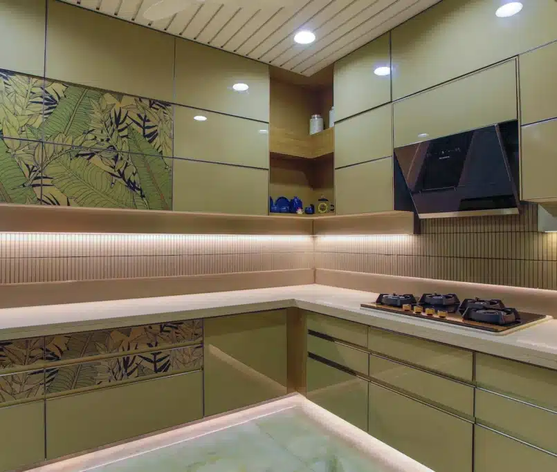 A modern kitchen featuring a wall of cabinets and an illuminated wall of lights, creating a bright and functional space.