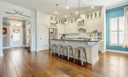 A kitchen featuring hardwood floors and blue walls, creating a warm and inviting atmosphere.