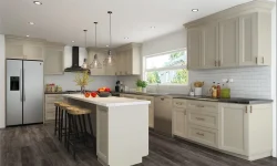 A modern kitchen featuring white cabinets and warm wood floors, creating a bright and inviting atmosphere.