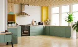 A modern kitchen featuring green cabinets complemented by vibrant yellow accents throughout the space.