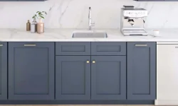 A modern kitchen featuring blue cabinets and elegant white countertops, creating a stylish and inviting atmosphere.