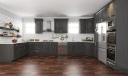 A modern kitchen featuring dark gray cabinets complemented by warm wood flooring.